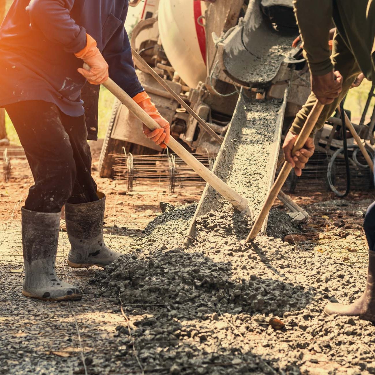 pouring concrete with worker mix cement at construction