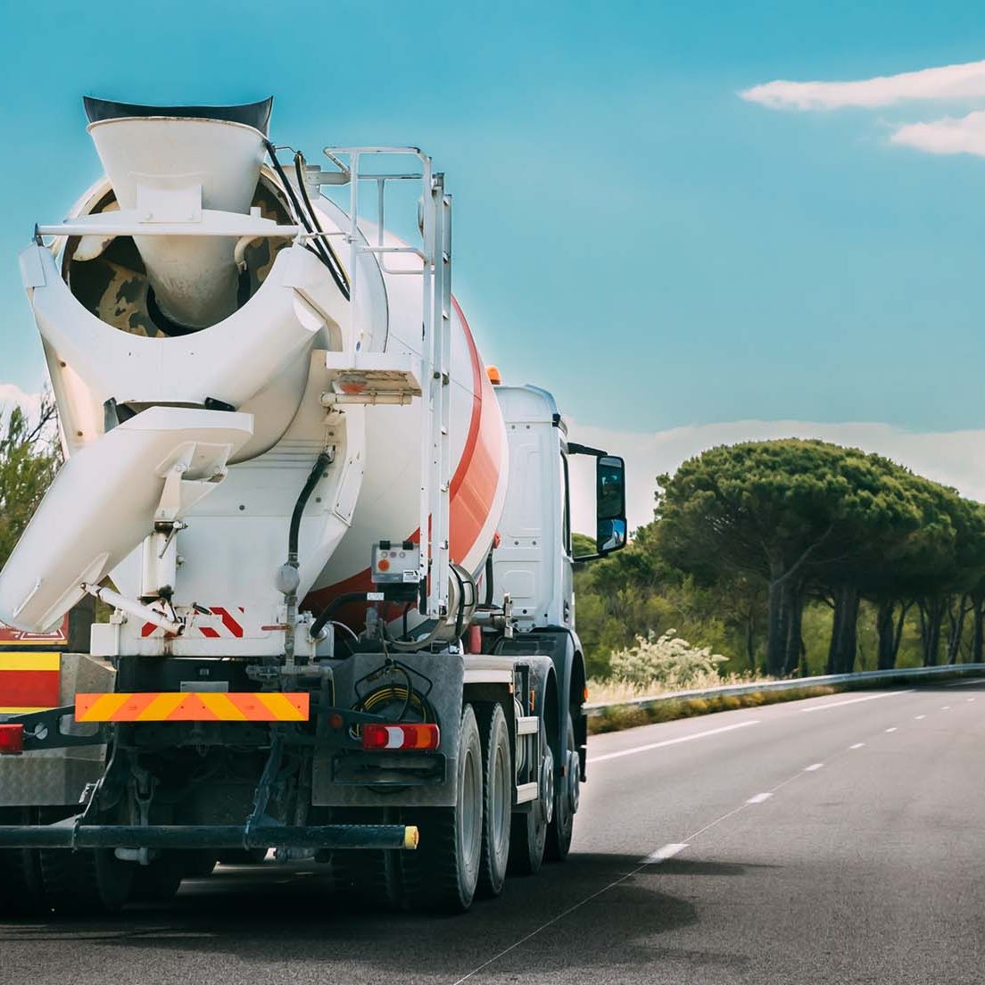 Special Concrete Transport Truck In-transit Mixer Unit In Motion On Country Road, Freeway. Freeway Motorway Highway. Business Drive Transportation And Development Concept. Concrete Truck Mixer